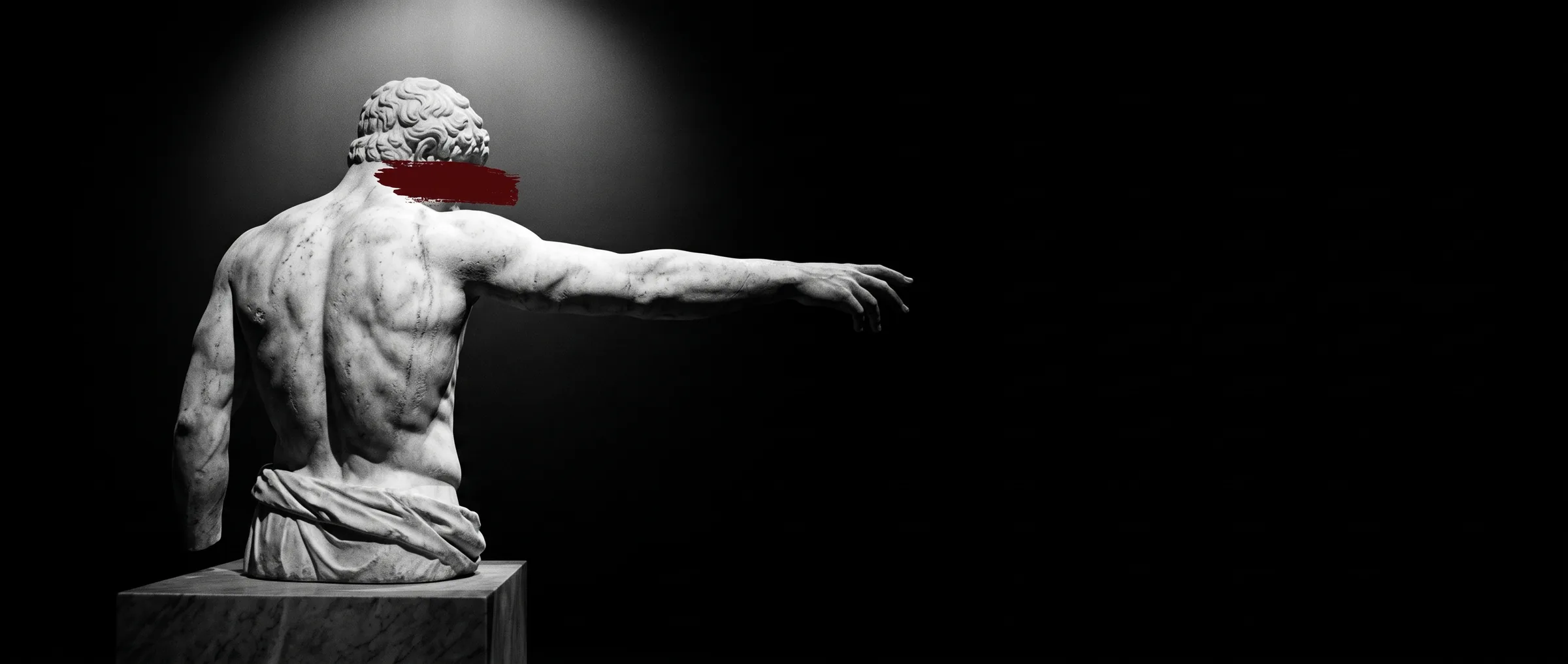 Marble statue seen from behind, arm extended into the dark
